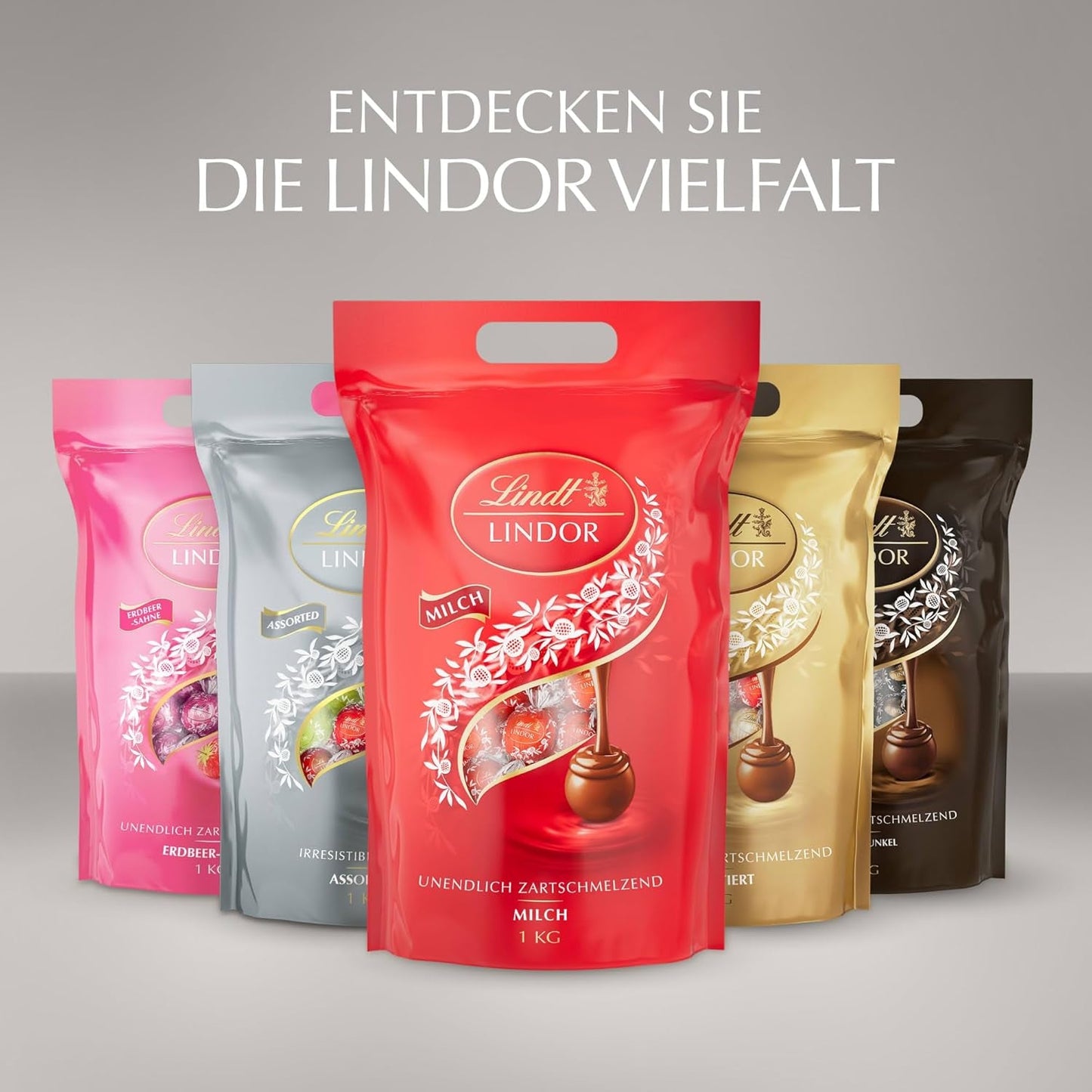 Lindt-chocolade | Diverse tassen LINDOR zilver | Zak van 1 kg | 80 smeltende melkchocoladebolletjes, 70%, gezouten karamel en dubbele chocoladesmaken | Chocoladegeschenk om te delen