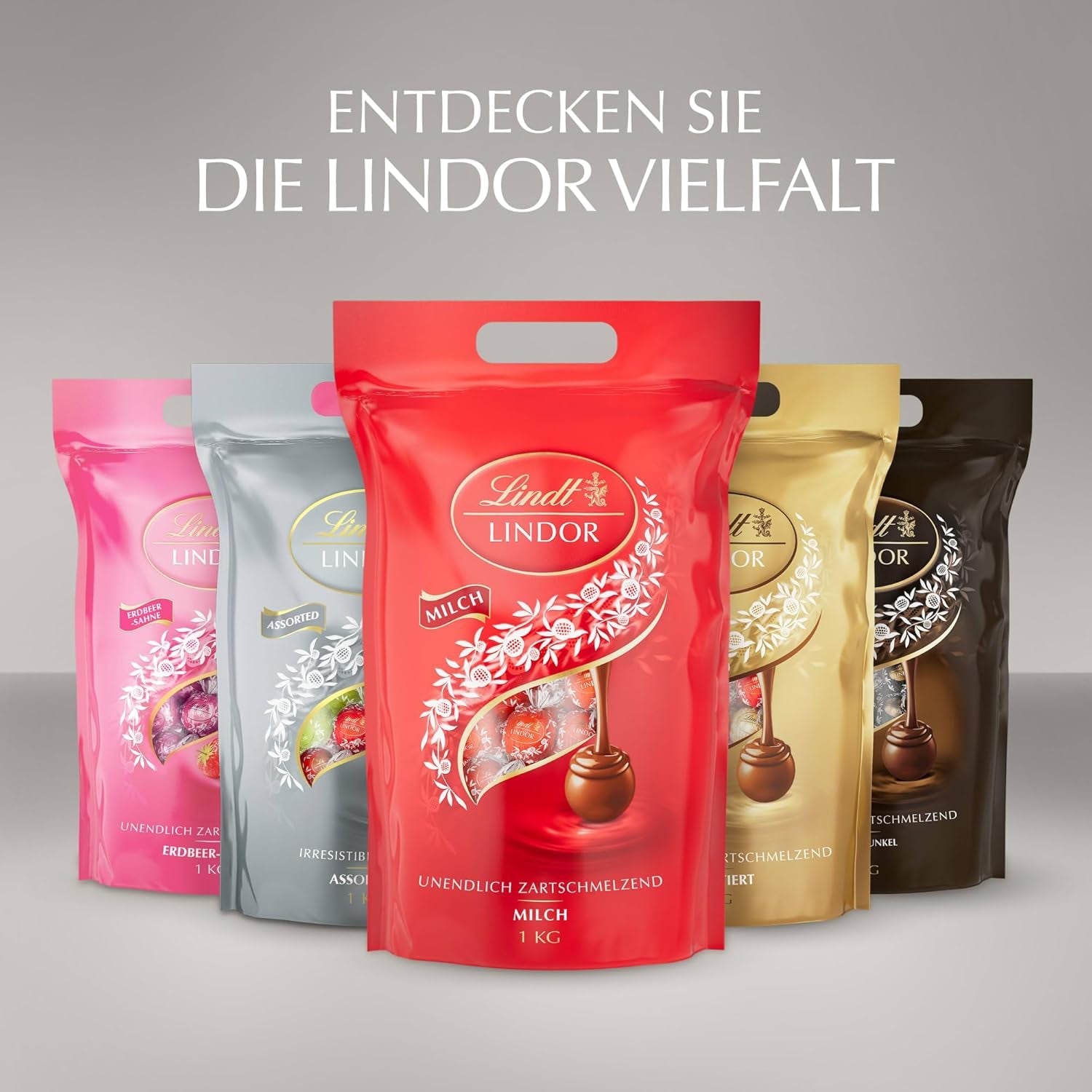 Lindt-chocolade | Diverse tassen LINDOR zilver | Zak van 1 kg | 80 smeltende melkchocoladebolletjes, 70%, gezouten karamel en dubbele chocoladesmaken | Chocoladegeschenk om te delen
